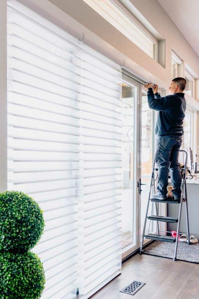 man measuring windows for the perfect window treatment Blind Guy of Tri-Cities