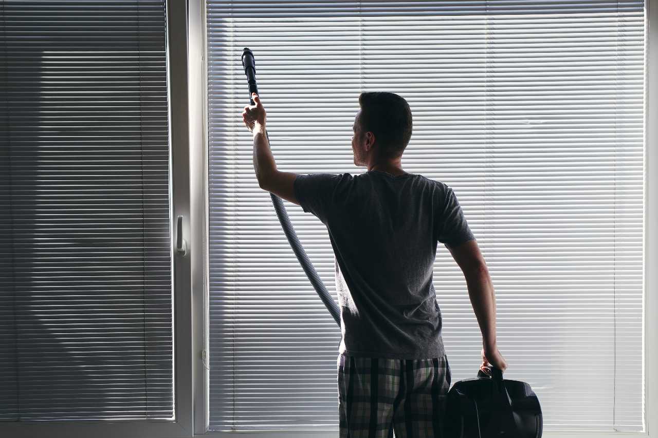 man trying to vacuum his custom blinds Blind Guy of Tri-Cities