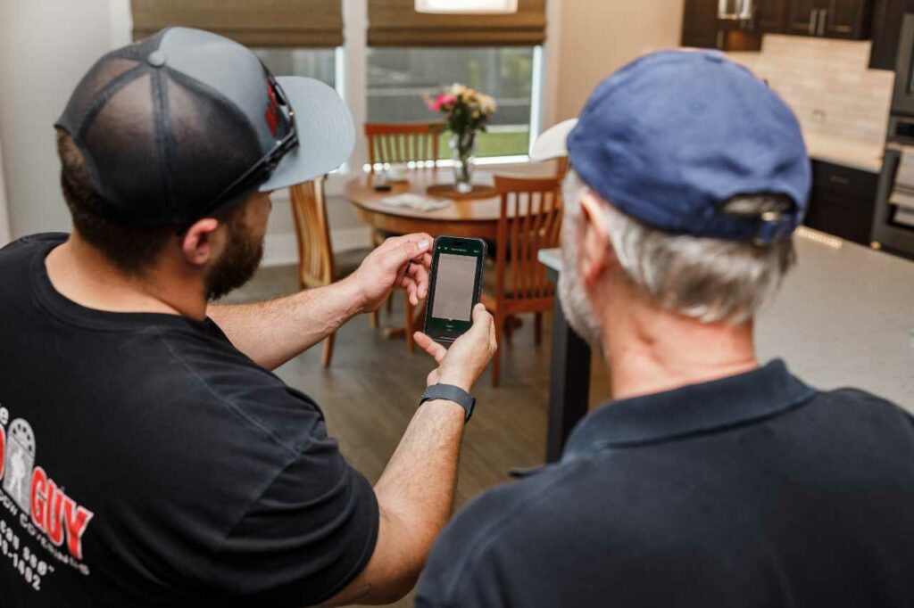 Blind Guy of Tri-Cities showing customer the compatibility of motorized blinds with smart home systems