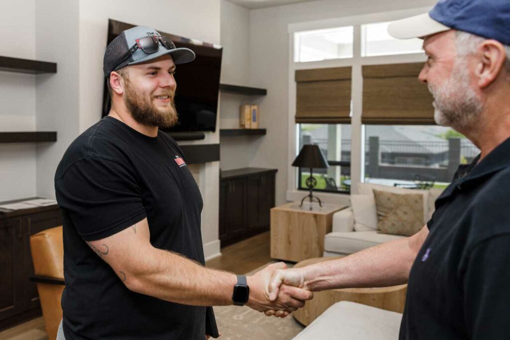 Blind Guy of Tri-Cities shaking hands with customer for motorized blinds done deal